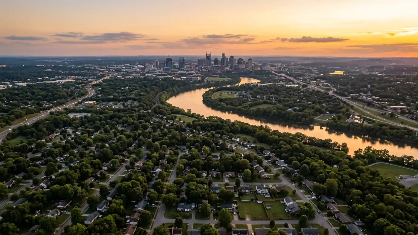 Window service areas | Nashville and Middle Tennessee A golden sunset aerial view of the Nashville skyline above tree-covered suburban neighborhoods with a winding river